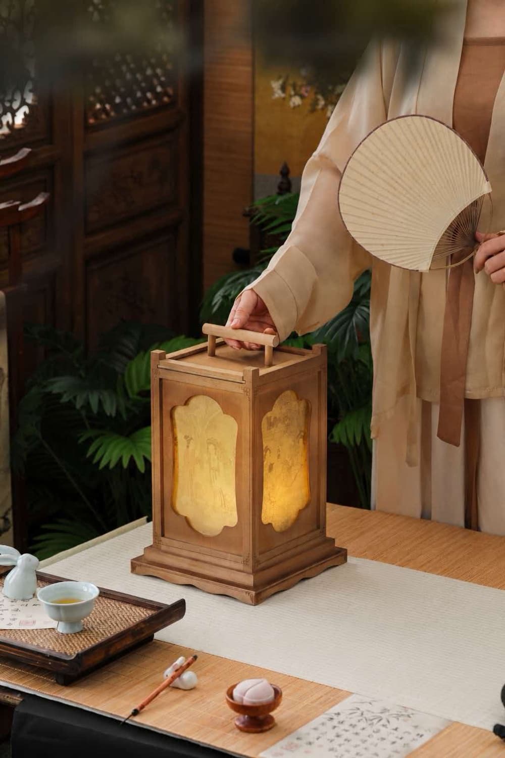 A traditional wooden lantern lit at dusk